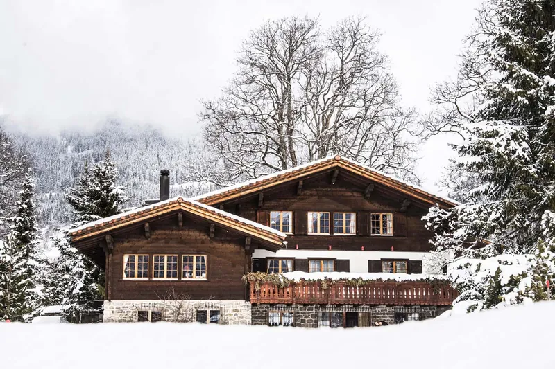 Chalet Valli, a dark-timber chalet in the snow